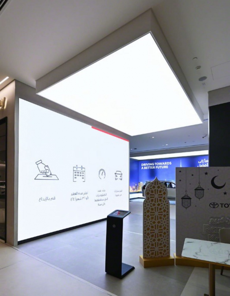 Large illuminated stretch ceiling feature installed above a premium automotive showroom, providing strong architectural impact and uniform lighting. Large illuminated stretch ceiling feature installed above a premium automotive showroom, providing strong architectural impact and uniform lighting.
