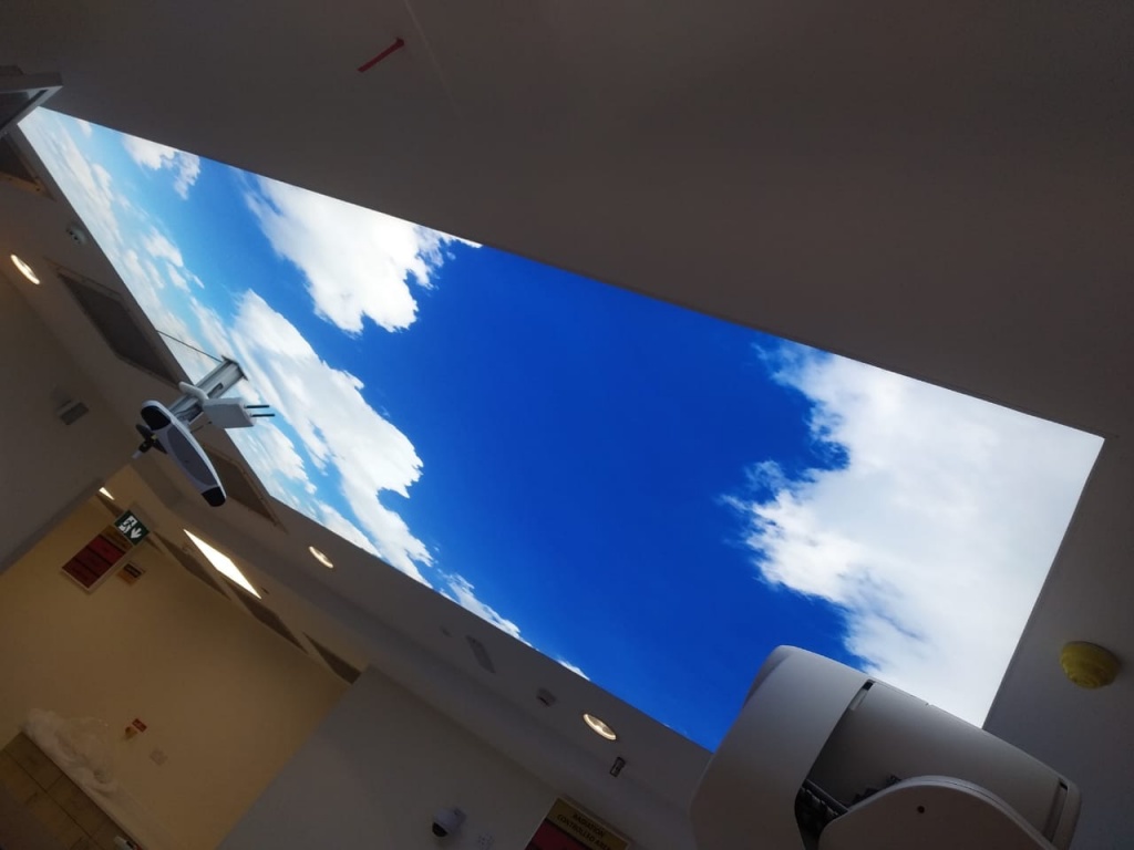 Large backlit printed sky stretch ceiling with blue sky and white clouds installed in a medical facility in Abu Dhabi, UAE. Large backlit printed sky stretch ceiling with blue sky and white clouds installed in a medical facility in Abu Dhabi, UAE.