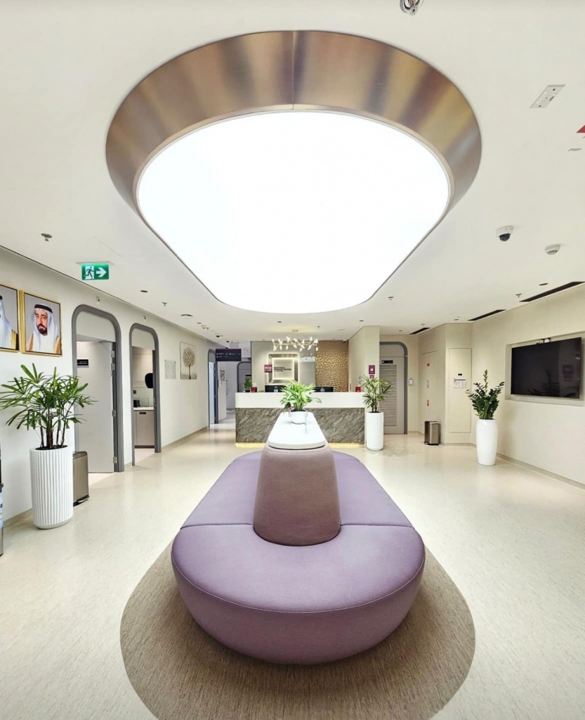 Custom luminous stretch ceiling panel featuring a seamless illuminated membrane and elegant curved geometry for a contemporary commercial interior. Custom luminous stretch ceiling panel featuring a seamless illuminated membrane and elegant curved geometry for a contemporary commercial interior.
