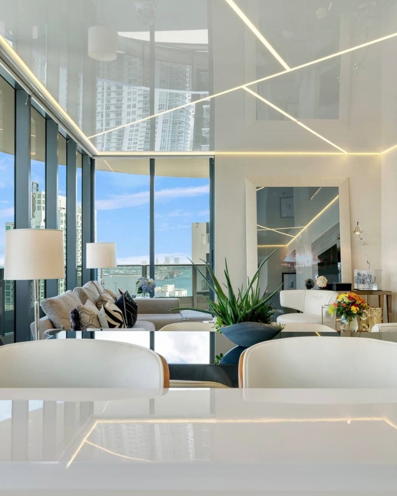 Luxury white glossy stretch ceiling reflecting panoramic sea views in a Dubai penthouse. Luxury white glossy stretch ceiling reflecting panoramic sea views in a Dubai penthouse.