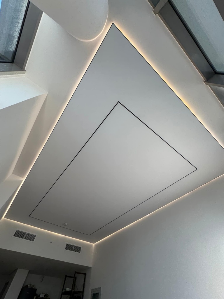 Custom white stretch ceiling installed in a luxury Dubai villa, featuring seamless PVC membrane, concealed perimeter LED lighting, integrated access panel, and a clean minimalist architectural design that enhances the spacious interior. Custom white stretch ceiling installed in a luxury Dubai villa, featuring seamless PVC membrane, concealed perimeter LED lighting, integrated access panel, and a clean minimalist architectural design that enhances the spacious interior.