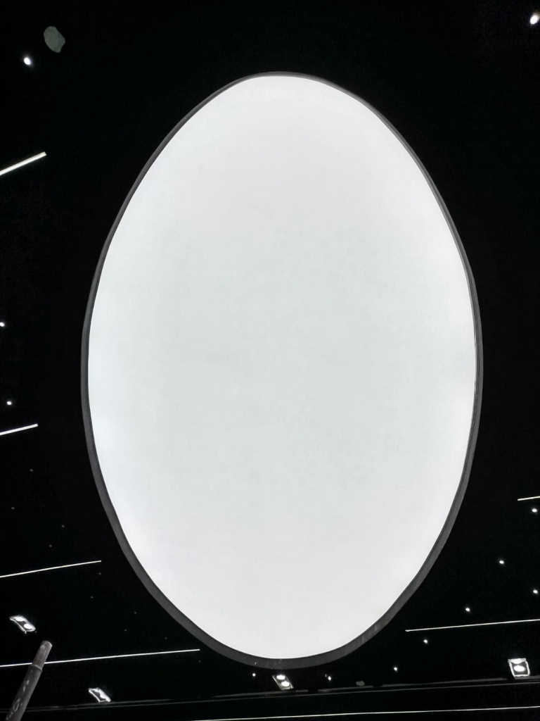 Large circular waterproof stretch ceiling with seamless translucent membrane and integrated architectural lighting. Large circular waterproof stretch ceiling with seamless translucent membrane and integrated architectural lighting.