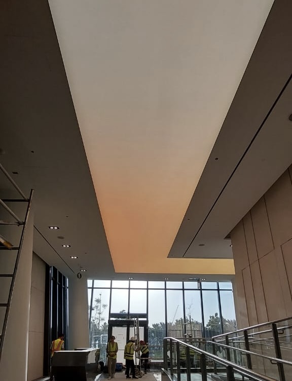 Custom backlit stretch ceiling designed to deliver soft, even illumination throughout a commercial reception area. Custom backlit stretch ceiling designed to deliver soft, even illumination throughout a commercial reception area.