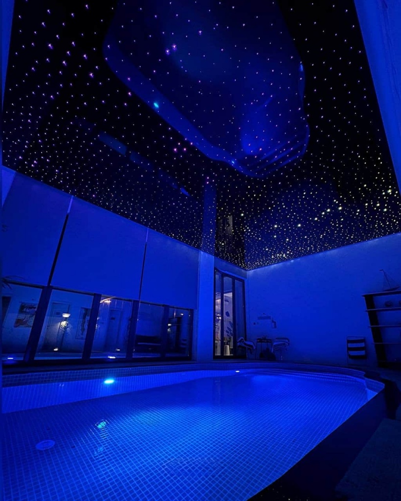 Glossy black stretch ceiling creating a spectacular night sky above a private indoor pool. Glossy black stretch ceiling creating a spectacular night sky above a private indoor pool.