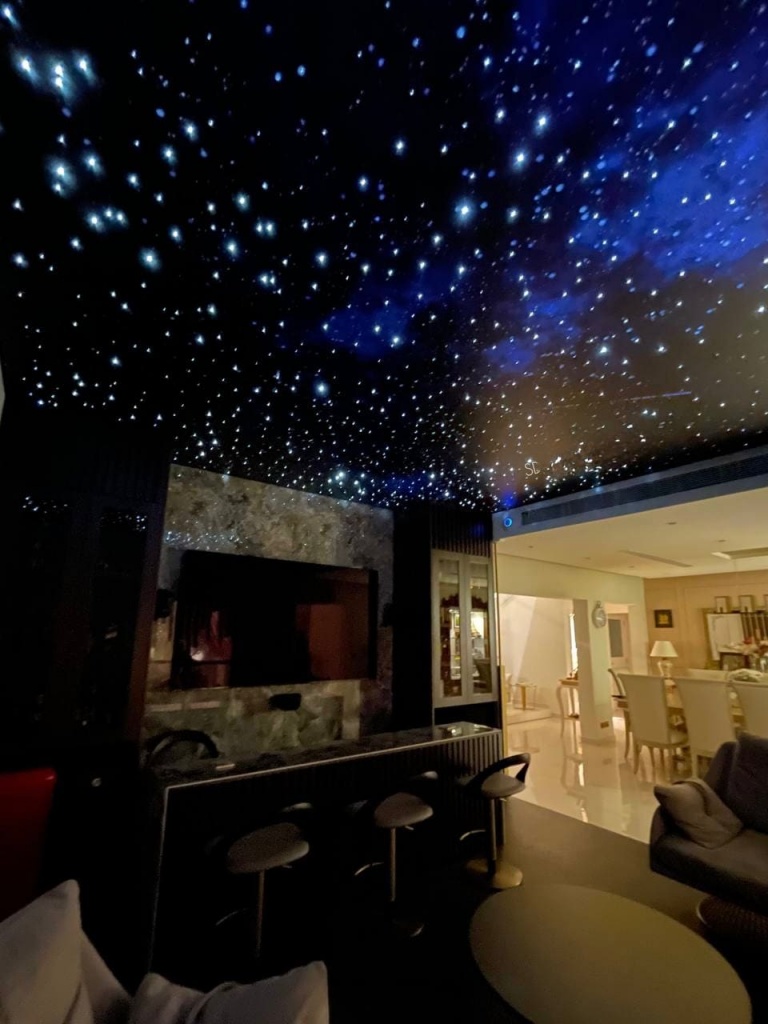 Modern Galaxy Ceiling integrated into a luxury penthouse interior with precision fiber optic lighting. Modern Galaxy Ceiling integrated into a luxury penthouse interior with precision fiber optic lighting.