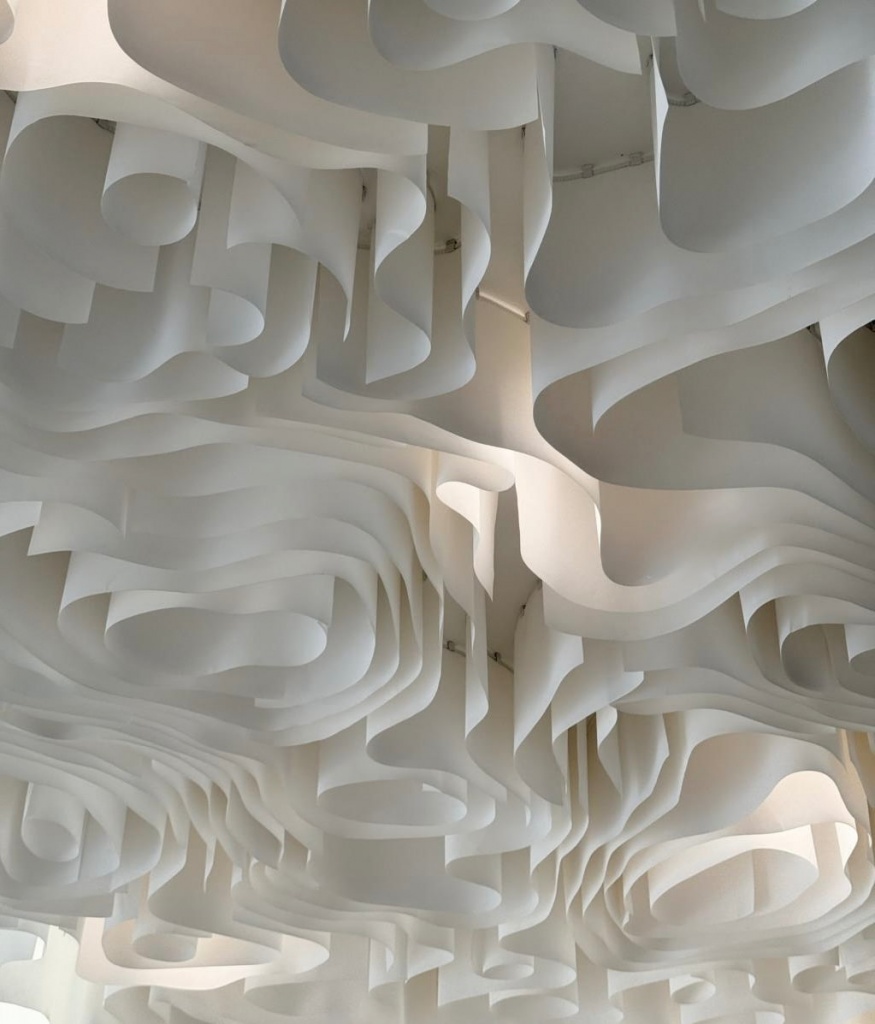 Premium architectural fabric ceiling featuring elegant flowing curves and soft integrated illumination. Premium architectural fabric ceiling featuring elegant flowing curves and soft integrated illumination.
