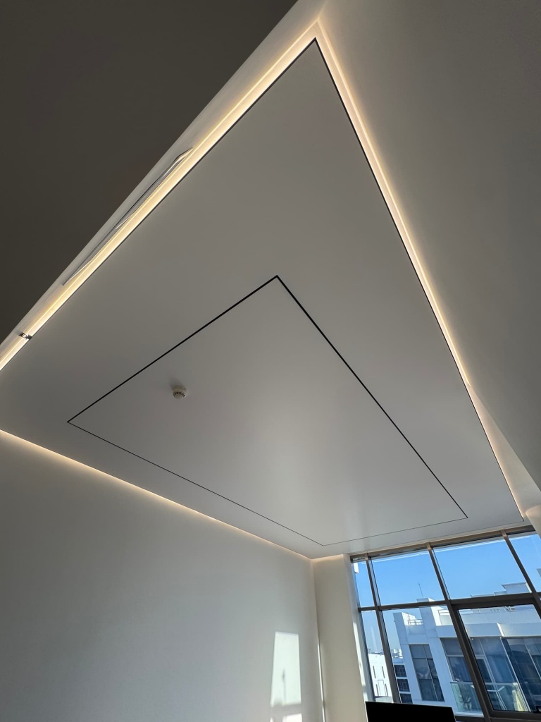 Custom-designed white stretch ceiling with hidden LED perimeter lighting, delivering elegant indirect illumination for a contemporary villa interior. Custom-designed white stretch ceiling with hidden LED perimeter lighting, delivering elegant indirect illumination for a contemporary villa interior.