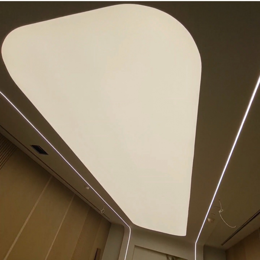 Large custom light ceiling with rounded corners delivering soft, shadow-free illumination in a luxury hospitality environment. Large custom light ceiling with rounded corners delivering soft, shadow-free illumination in a luxury hospitality environment.