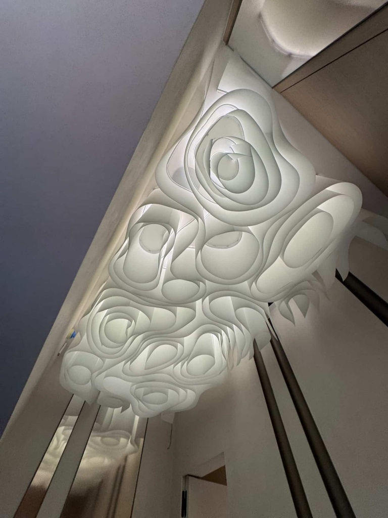 Custom architectural fabric ceiling with flowing sculptural forms and concealed LED lighting installed in a luxury Dubai villa. Custom architectural fabric ceiling with flowing sculptural forms and concealed LED lighting installed in a luxury Dubai villa.