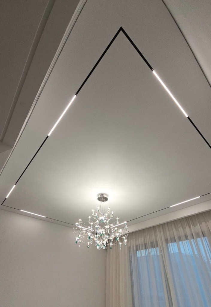 Modern bespoke illuminated ceiling with recessed perimeter lighting creating a clean contemporary interior. Modern bespoke illuminated ceiling with recessed perimeter lighting creating a clean contemporary interior.