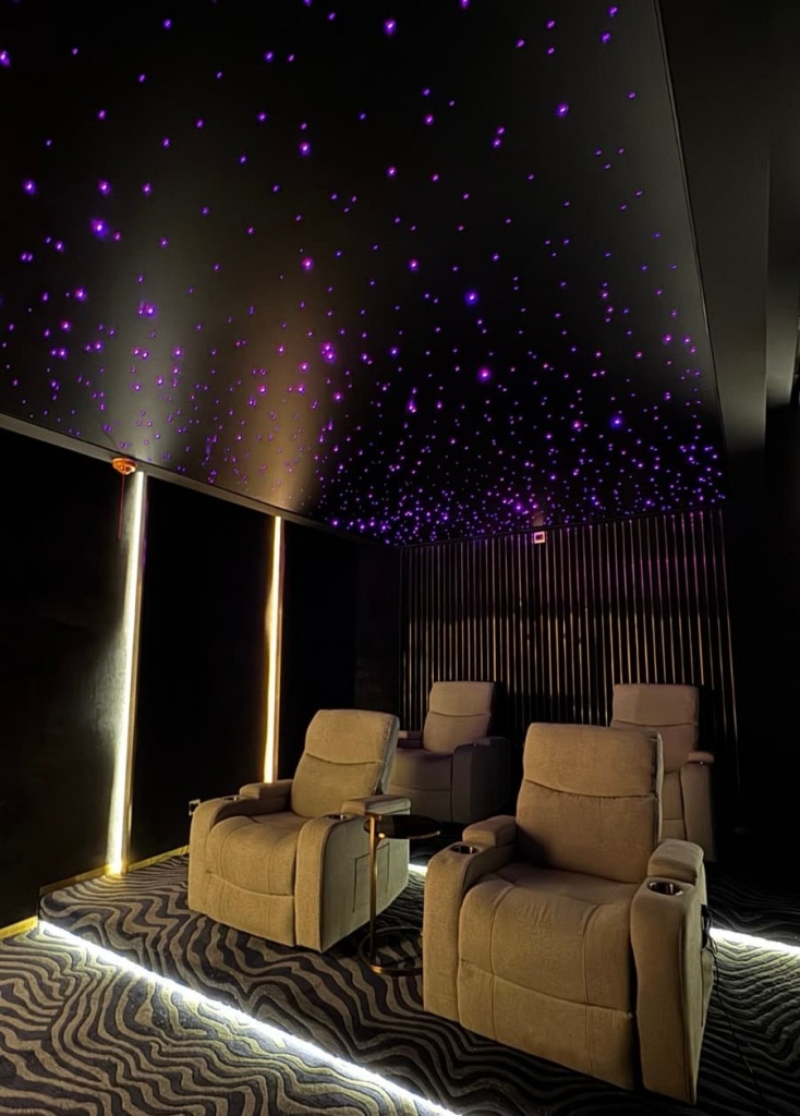 Luxury fiber optic star ceiling installed in a private home cinema in Dubai. The black stretch ceiling creates a realistic night sky effect using hundreds of individually positioned fiber optic stars. Luxury fiber optic star ceiling installed in a private home cinema in Dubai. The black stretch ceiling creates a realistic night sky effect using hundreds of individually positioned fiber optic stars.