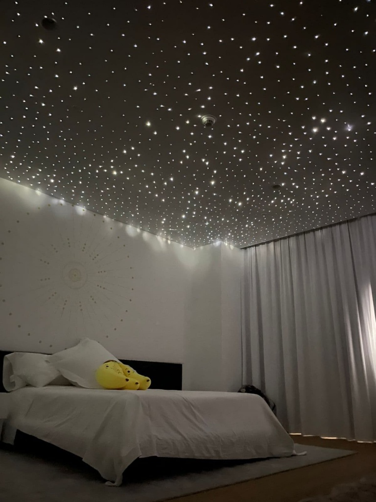 High-density fiber optic star ceiling creating a dramatic contemporary night-sky effect in a modern luxury bedroom. High-density fiber optic star ceiling creating a dramatic contemporary night-sky effect in a modern luxury bedroom.