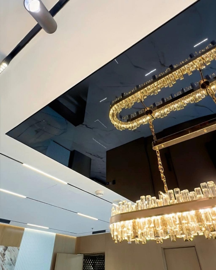 Premium black glossy ceiling creating elegant reflections and visual depth in a contemporary corporate office interior. Premium black glossy ceiling creating elegant reflections and visual depth in a contemporary corporate office interior.