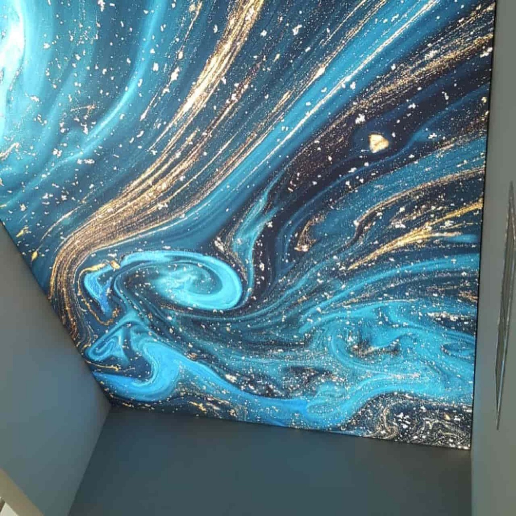 Custom printed stretch ceiling with realistic planet and space artwork illuminated by integrated lighting. Custom printed stretch ceiling with realistic planet and space artwork illuminated by integrated lighting.