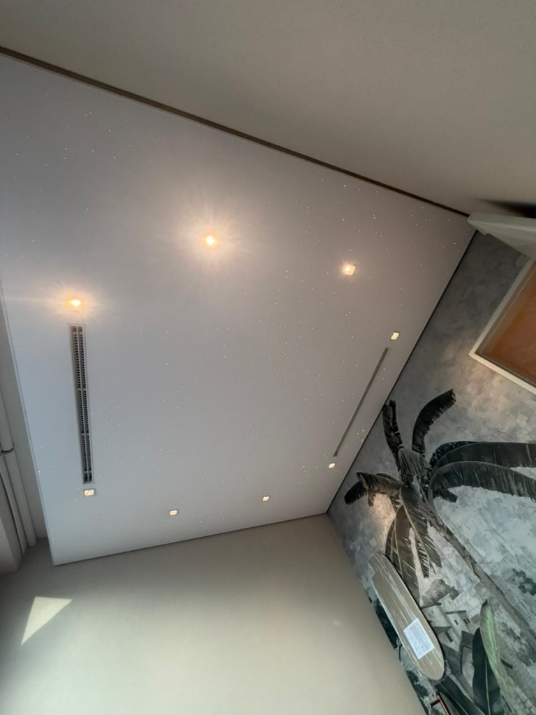 Custom white fiber optic star ceiling integrated into a luxury bedroom interior with recessed lighting and HVAC. Custom white fiber optic star ceiling integrated into a luxury bedroom interior with recessed lighting and HVAC.