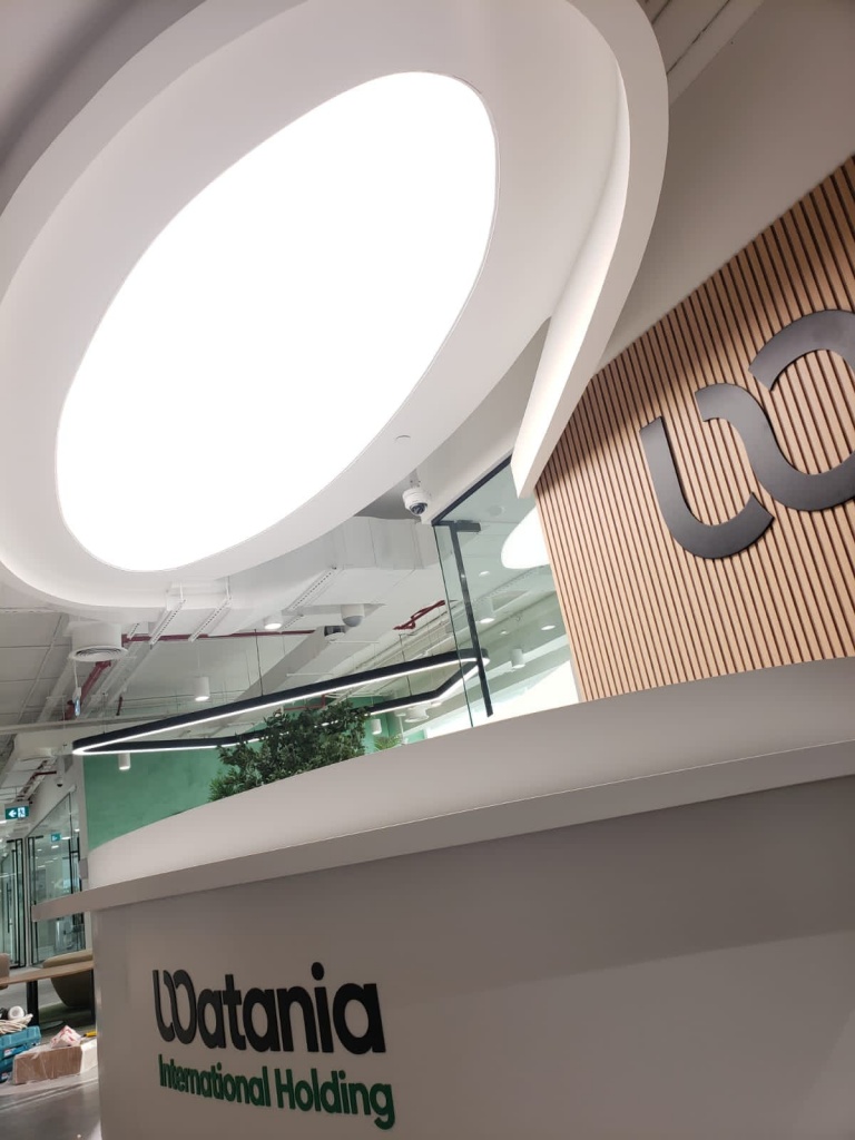 Custom rounded illuminated ceiling feature integrated above a modern reception desk, combining architectural design with functional lighting. Custom rounded illuminated ceiling feature integrated above a modern reception desk, combining architectural design with functional lighting.
