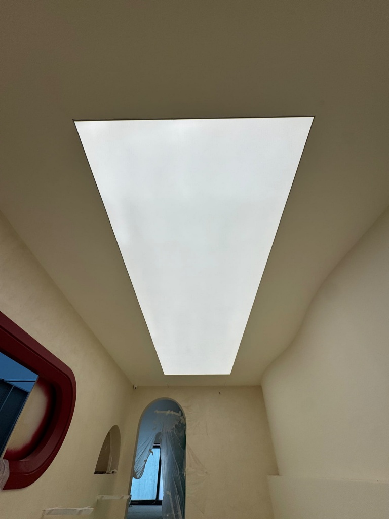 Large rectangular translucent stretch ceiling with integrated LED backlighting creating a smooth and uniform luminous surface. Large rectangular translucent stretch ceiling with integrated LED backlighting creating a smooth and uniform luminous surface.