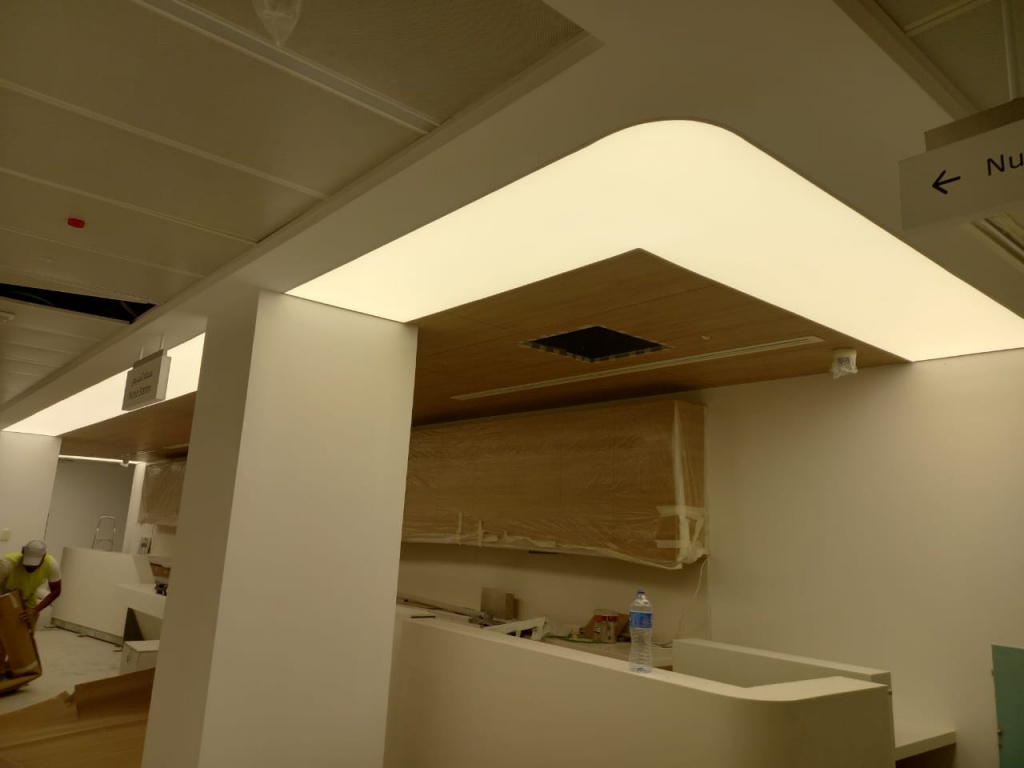 Large illuminated stretch ceiling providing uniform ambient lighting for a reception and waiting area. Large illuminated stretch ceiling providing uniform ambient lighting for a reception and waiting area.